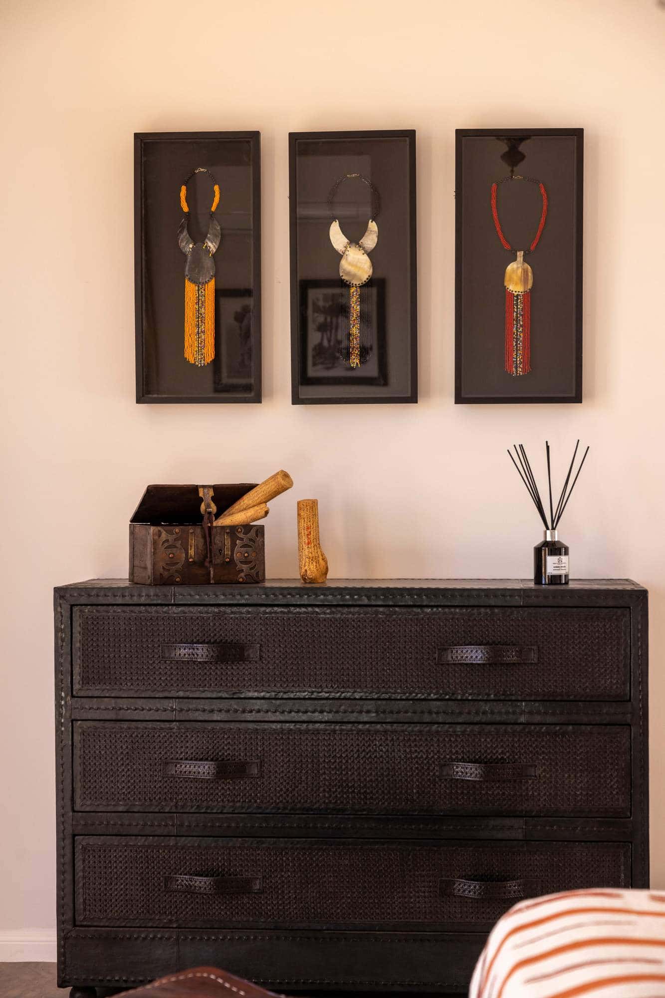 Imlil Suite at Villa Yemna in Marrakech, chest of drawers and wall decoration, head-on view.